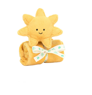 Yellow plush sun toy with a blanket on a white background