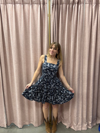Woman in a floral dress lying on a textured surface