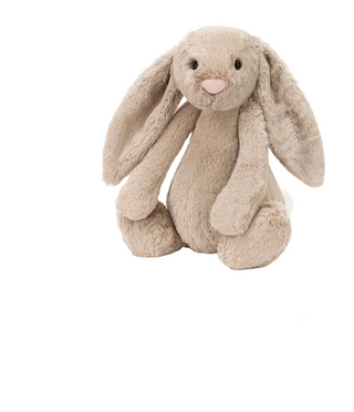 A plush beige bunny stuffed animal with long floppy ears, black eyes, and a pink nose, shown on a white background above product text. A dark green macOS dock with app icons is visible along the bottom edge.