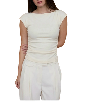 Person wearing a white outfit against a striped background