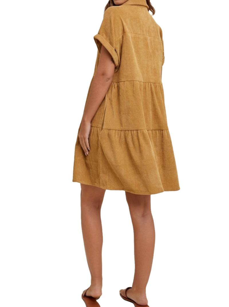 Camel Cozy Corduroy Tiered Dress  A fun camel corduroy mini dress with tiered layers and short cuffed sleeves. The button-front detail adds a classic touch, while the warm camel color exudes timeless comfort and versatility. This dress effortlessly combines comfort and style for a fashionable ensemble.  Material:  80% Polyester, 8% Nylon, 2% Spandex back