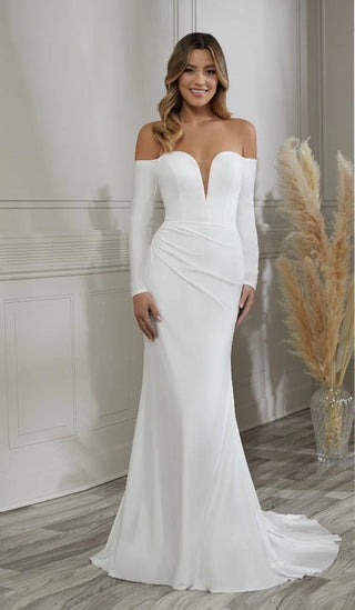 Woman wearing a white off-shoulder gown in a room with a neutral background