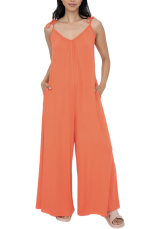 Coquina Coral Jumpsuit  This soft and drapey lounge jumper features an oversized loose fit for maximum comfort. the drop crotch design makes this piece super stylish while the adjustable straps tie at the shoulder creating the ideal fit. It's great for wearing around the house or layering over a tee or bralette.  95% viscose 5% spandex