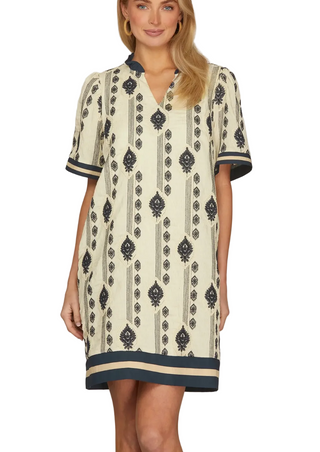 A woman wearing a Cream & Navy Embroidered Mini Dress