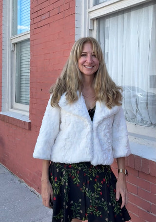 a woman wearing z Cream Faux Fur Jacket