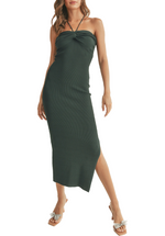 A forest green knit dress with a tie-back neckline and a knot detail is a versatile and elegant addition to any wardrobe. Its comfortable knit fabric, unique neckline, and charming knot detail make it a fashionable choice for a range of occasions, all while exuding an air of effortless style and comfort.