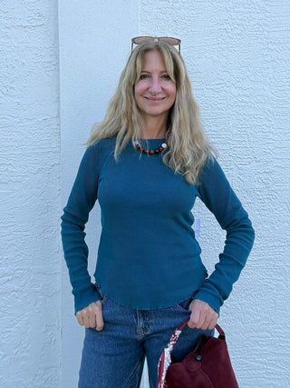 a woman wearing  a teal free people Easy Does It LS Tee in Still Sea Free People