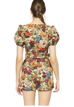 Falling For You Floral Romper is a floral print, puff sleeve, square neck romper featuring pockets at side. Belted waist. Zipper closure at back. Unlined.   Back View. 70% Polyester 30% Cotton