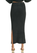 a black midi skirt that is soft and fluffy is the epitome of elegance and comfort. It combines a rich color, a luxurious texture, and a flattering silhouette, making it a fashion-forward choice for various occasions where you want to make a statement.(back)