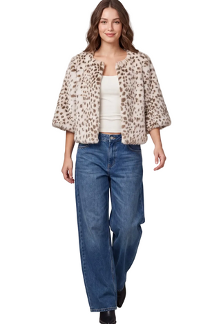 A woman wearing a  cream Fawn Faux Fur Jacket