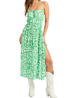Fields of Green Midi Dress  Spaghetti strap midi dress with backless detail and front tie. 100% Viscose Lining: 97% Polyester 3% Spandex  Material: 100% Viscose.   Lining: 97% Polyester 3% Spandex