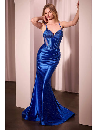 Woman wearing a blue evening gown against a neutral background