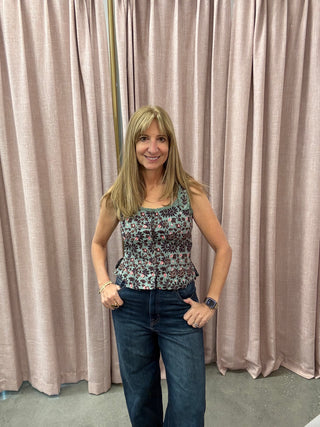 Woman posing in front of a beige curtain