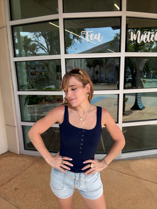Woman posing in front of a window with a building reflection