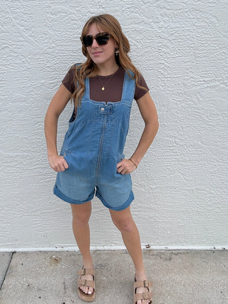woman in a Free People  denim Jude Shortall in Light Indigo romper