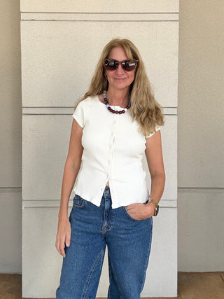 A woman wearing Free People Most Wanted Cardi in Ivory