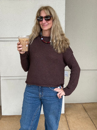 a woman wearing  a Free People Opal Rollneck Knit Sweater - Brown