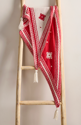  a red and cream knit scarf with tassels, 