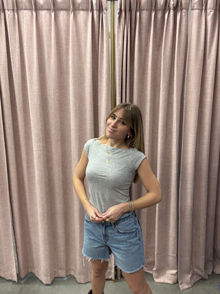 Person standing in front of a pleated curtain