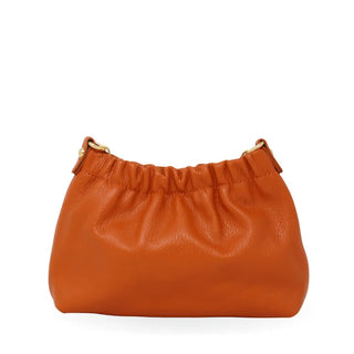 Orange leather handbag on a white background