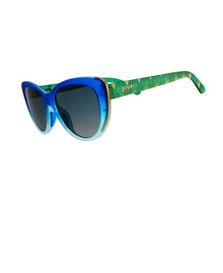 A pair of kids' sunglasses with a blue and light blue gradient frame, dark gray lenses, and green patterned arms with the brand name 'sozoo' printed on them, shown on a white background.