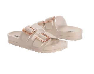 Beige sandals with rose gold buckles on a white background