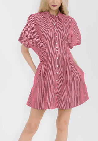 Woman wearing a red and white striped dress on a white background