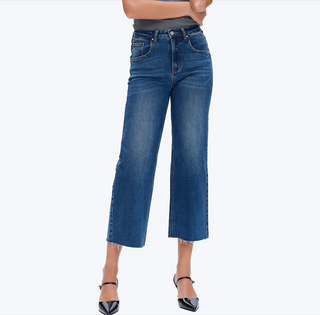 a woman wearing High Rise Cropped Distressed Wide Leg Jeans