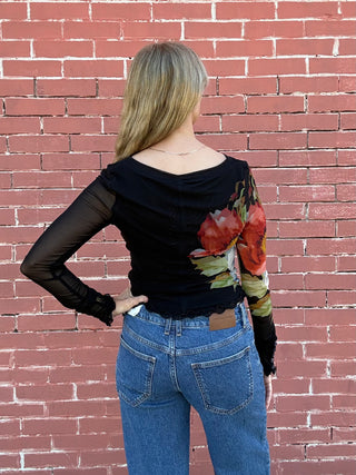  a woman wearinf a blcak Free People Lilly Printed Longsleeve Top Black Combo top