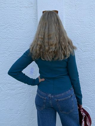a woman wearing  a teal free people Easy Does It LS Tee in Still Sea Free People