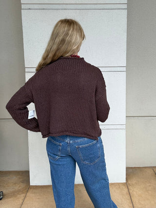 a woman wearing  a Free People Opal Rollneck Knit Sweater - Brown