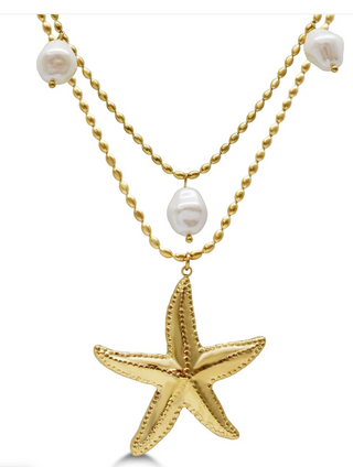 A gold-tone double-strand necklace featuring a large starfish pendant and three white baroque pearls, shown on a plain white background.