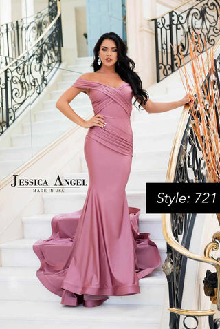 Woman in a pink evening gown standing on a staircase with 'Jessica Angel' branding.