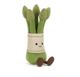 Plush toy asparagus with a smiling face on a white background