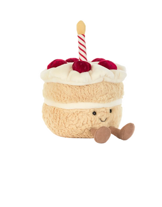 Plush toy birthday cake with a candle on a white background