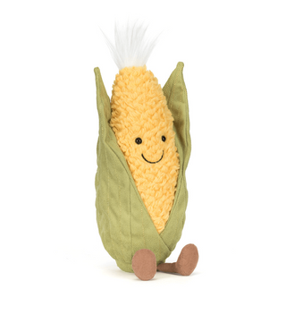 Plush toy resembling a corn on the cob with a smiling face on a white background
