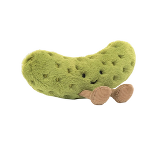 Plush pickle toy with a smiling face on a white background