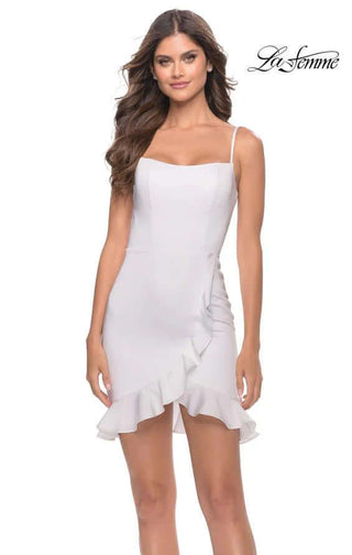Woman wearing a white dress with ruffled hem on a white background, branded 'La Femme'.