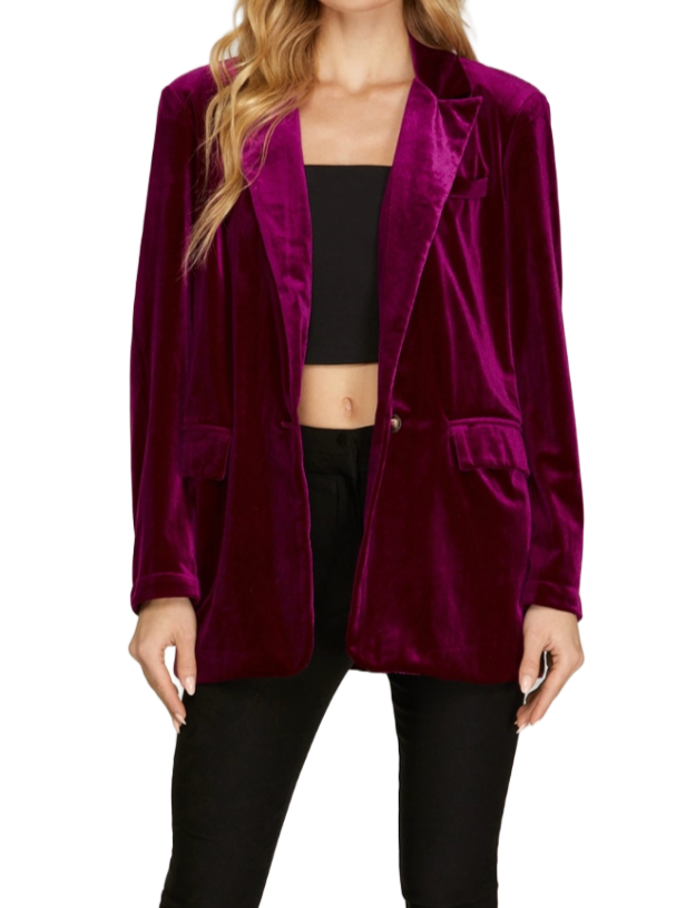 Magenta Velvet Chic Blazer  This single-button velvet blazer in magenta is a luxurious and vibrant addition to your wardrobe. Crafted from soft, plush velvet fabric, it exudes elegance and style. The single-button closure adds a sophisticated touch, making it perfect for dressing up your outfit with a bold pop of color.