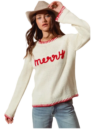 a woman wearinf a cream Merry Christmas Sweater