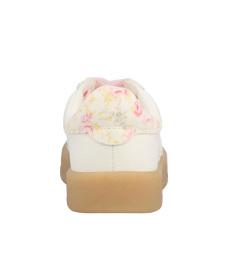 White sneaker with floral pattern on top and brown sole on a computer screen background