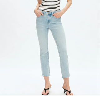 a woman wearing Mid Rise Cropped Stepped Hem Bootcut Jeans