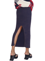 Nautical Nights Ribbed Maxi Skirt  A versatile ribbed knit maxi skirt in a rich garment-washed navy hue. Its classic design features a stylish back slit, offering both elegance and comfort for versatile, timeless fashion.   Material: 90% Cotton, 40% Polyester back