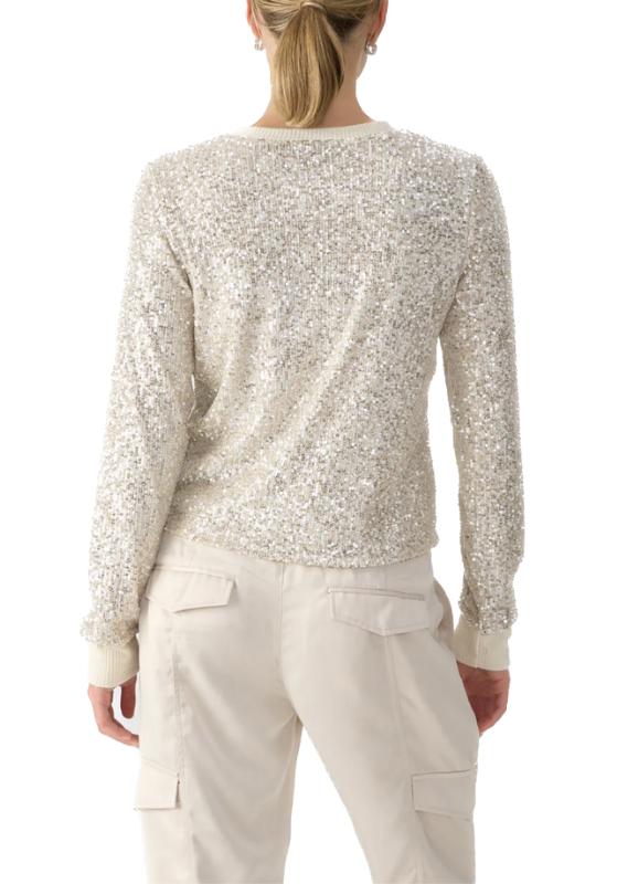 A lightweight oatmeal sequins long sleeve top is a fashionable and comfortable addition to any wardrobe, offering versatility and a touch of glamour to your outfit choices.  Self: 94% Polyester 6% Spandex  Lining: 100% Polyester(back)