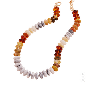 Necklace with multicolored beads on a beige background