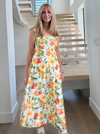 Woman wearing a floral dress in a modern indoor setting