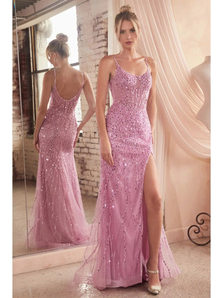Woman in a pink beaded evening gown standing in front of a mirror.