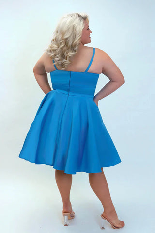 Woman wearing a blue dress against a white background