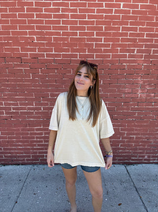 Person standing on a red brick sidewalk and gray pavement