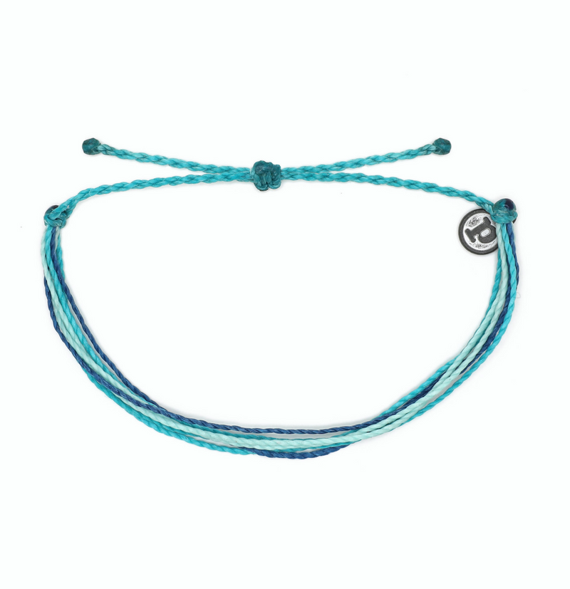 Pura Vida Bright Original Bracelet in Under the Sea  It’s the bracelet that started it all. Each one is handmade, waterproof and totally unique—in fact, the more you wear it, the cooler it looks. Grab yours today to feel the Pura Vida vibes.  Brand: Pura Vida Material: Wax-Coated Size & Fit: Adjustable from 2-5 Inches in Diameter
